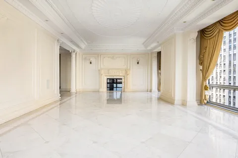a lobby with furniture and floor to ceiling window