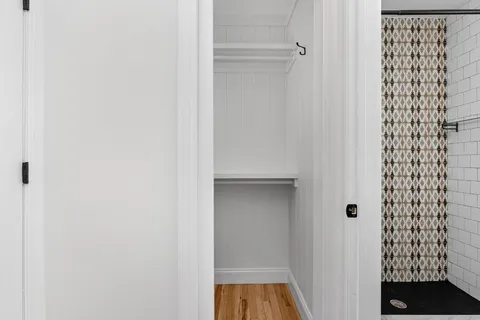 a view of a workspace with wooden floor and a window