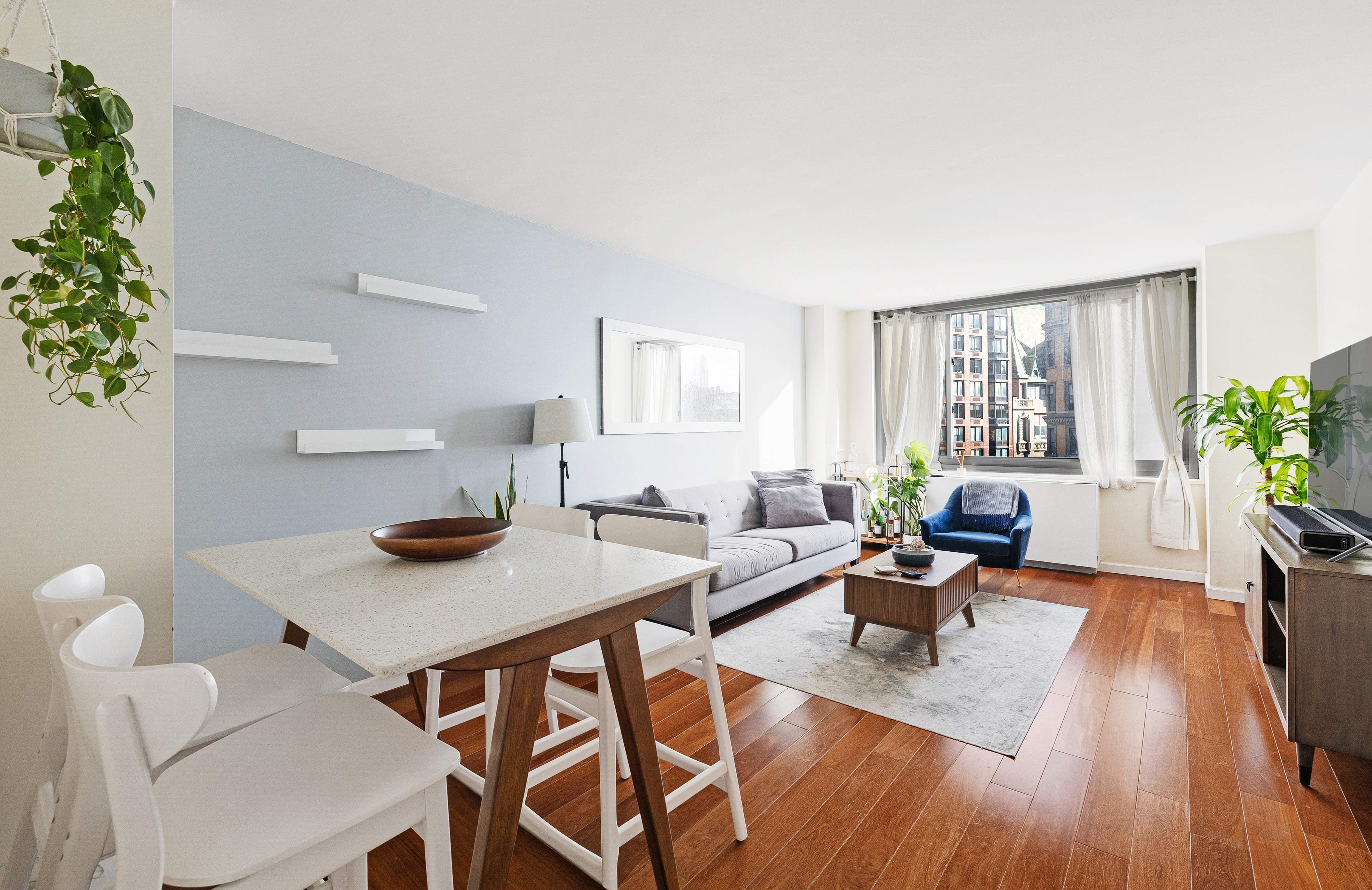 2025 Broadway, Unit 9F Manhattan, NY 10023 - Photo 1 of 11 a living room with furniture and a potted plant