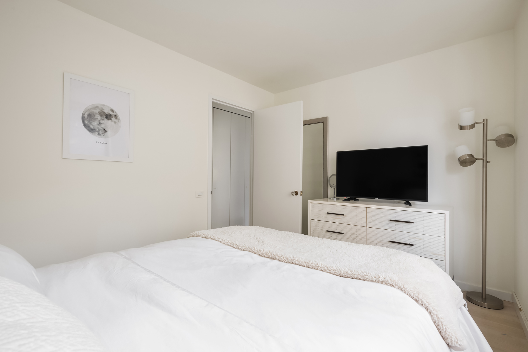330 East 75th Street, Unit 3L Manhattan, NY 10021 - Photo 6 of 14 a bedroom with a bed and a flat screen tv
