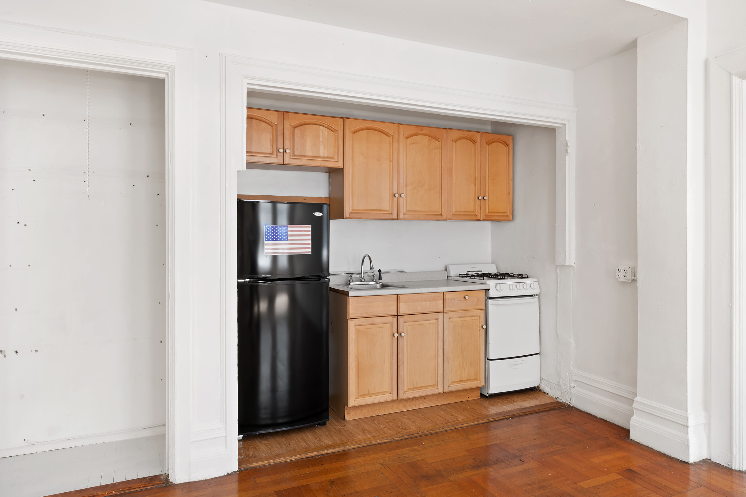 284 5th Avenue, Unit 6E Manhattan, NY 10001 - Photo 7 of 12 a kitchen with stainless steel appliances granite countertop a refrigerator and a stove top oven