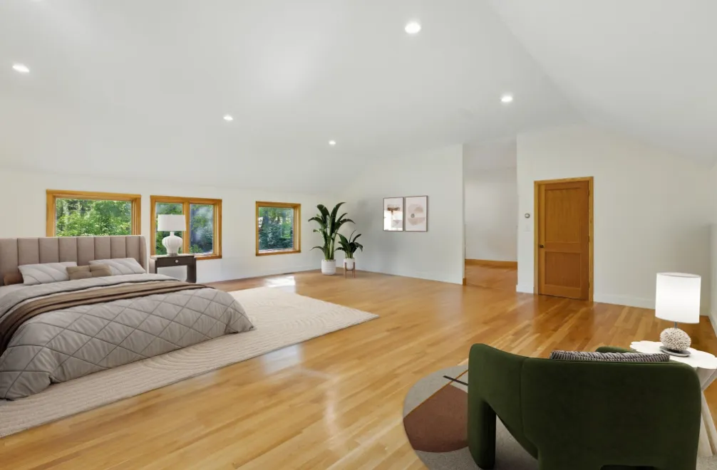 a spacious bedroom with a large bed and a couch