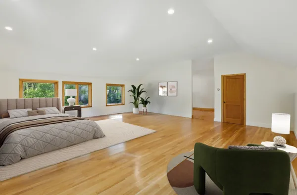 a spacious bedroom with a large bed and a couch