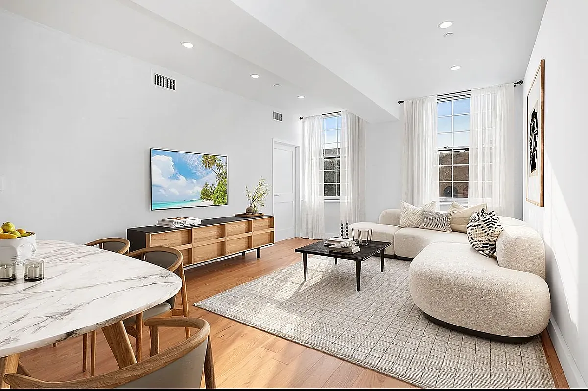 a living room with furniture and a potted plant