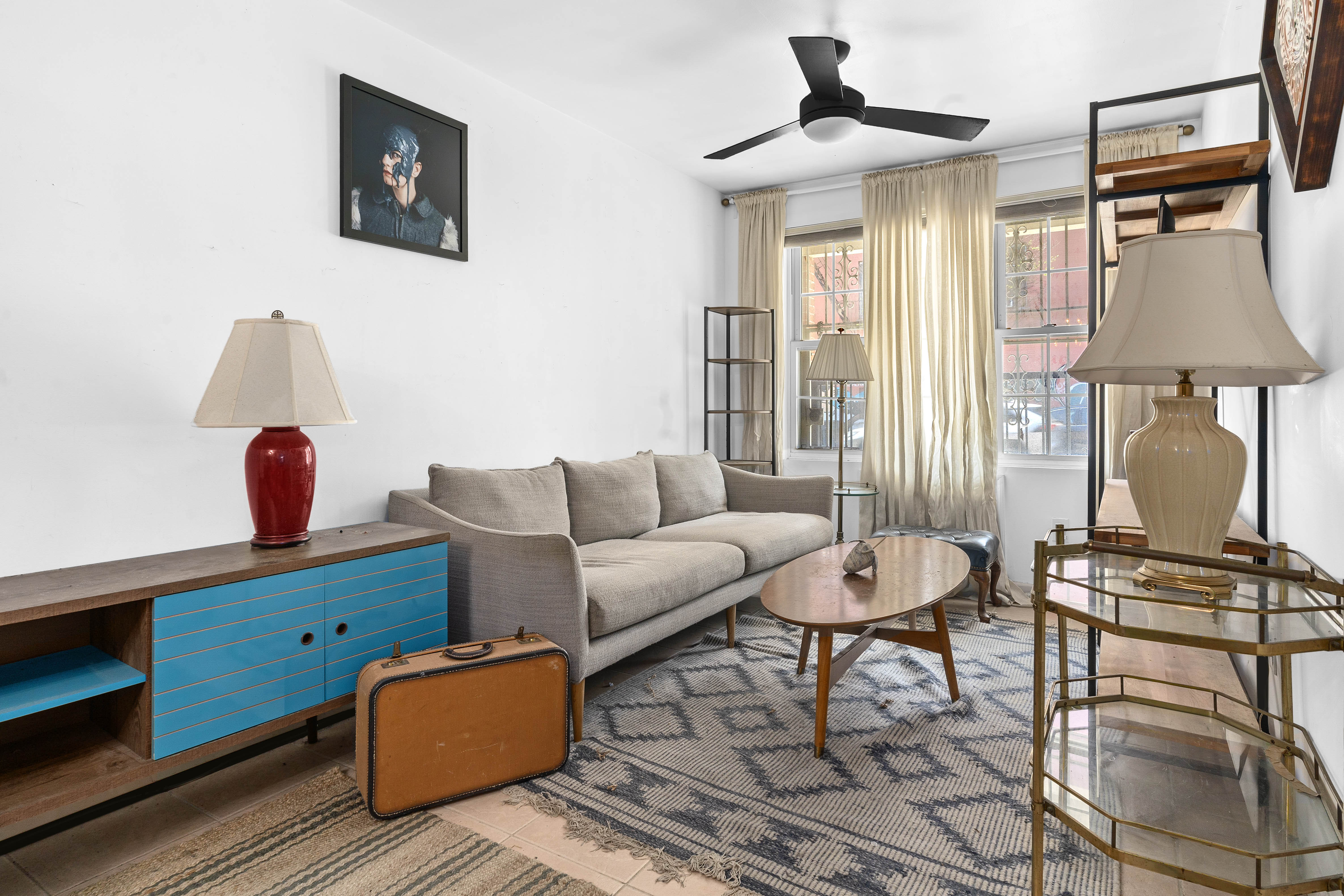 547 Gates Avenue, Unit 1 Brooklyn, NY 11216 - Photo 2 of 7 a living room with furniture and a window