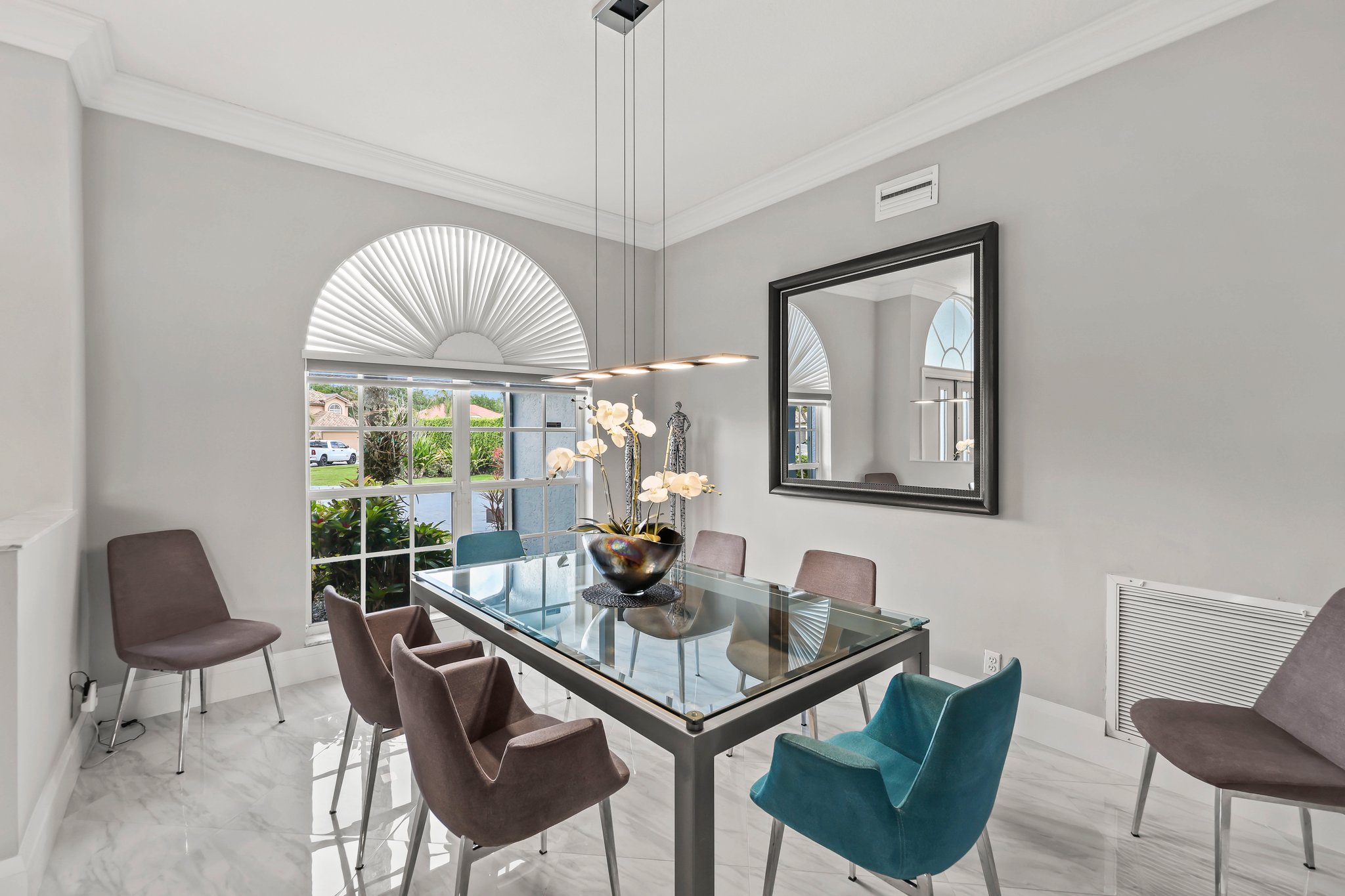 20317 Hacienda Court Boca Raton, FL 33498 - Photo 12 of 100 a dining room with furniture a window and a chandelier
