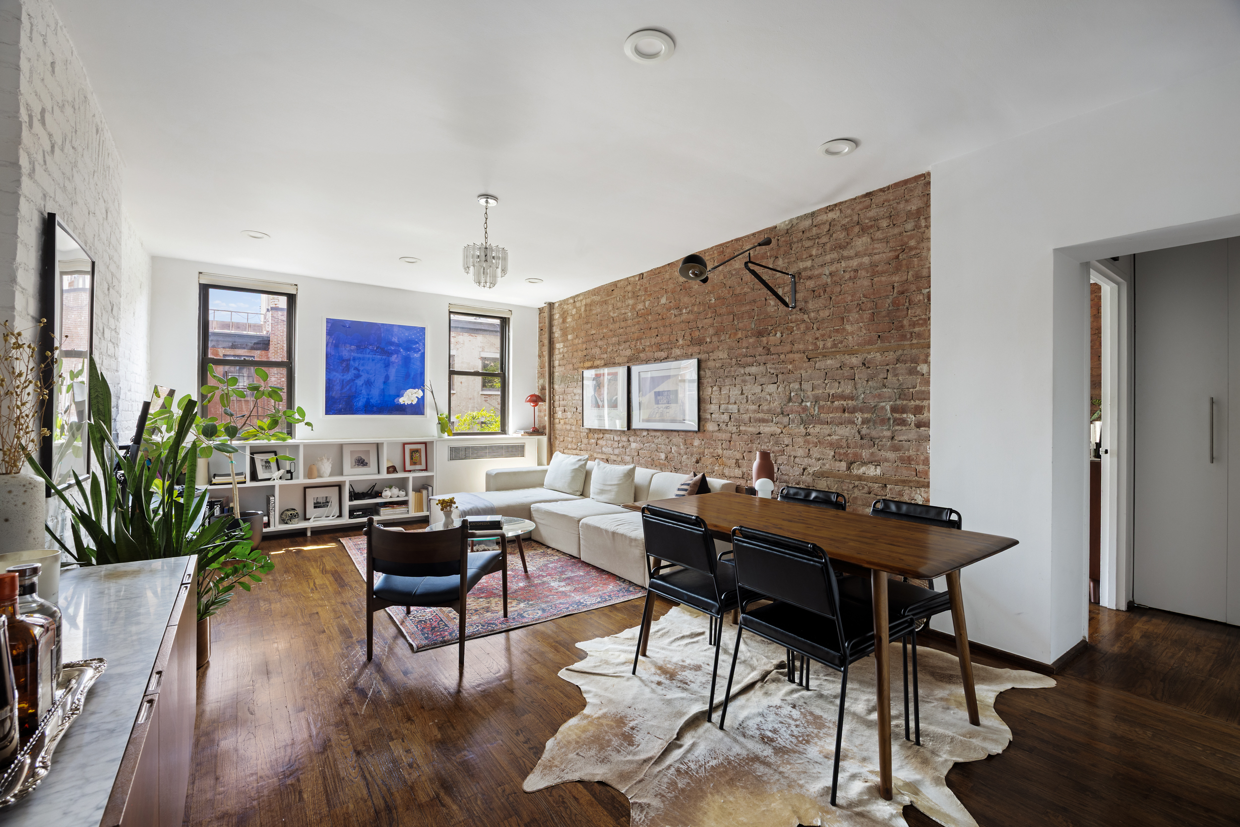 a living room with furniture and wooden floor