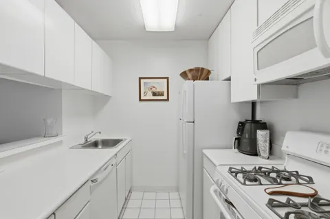 a kitchen with stainless steel appliances a sink a stove and a refrigerator