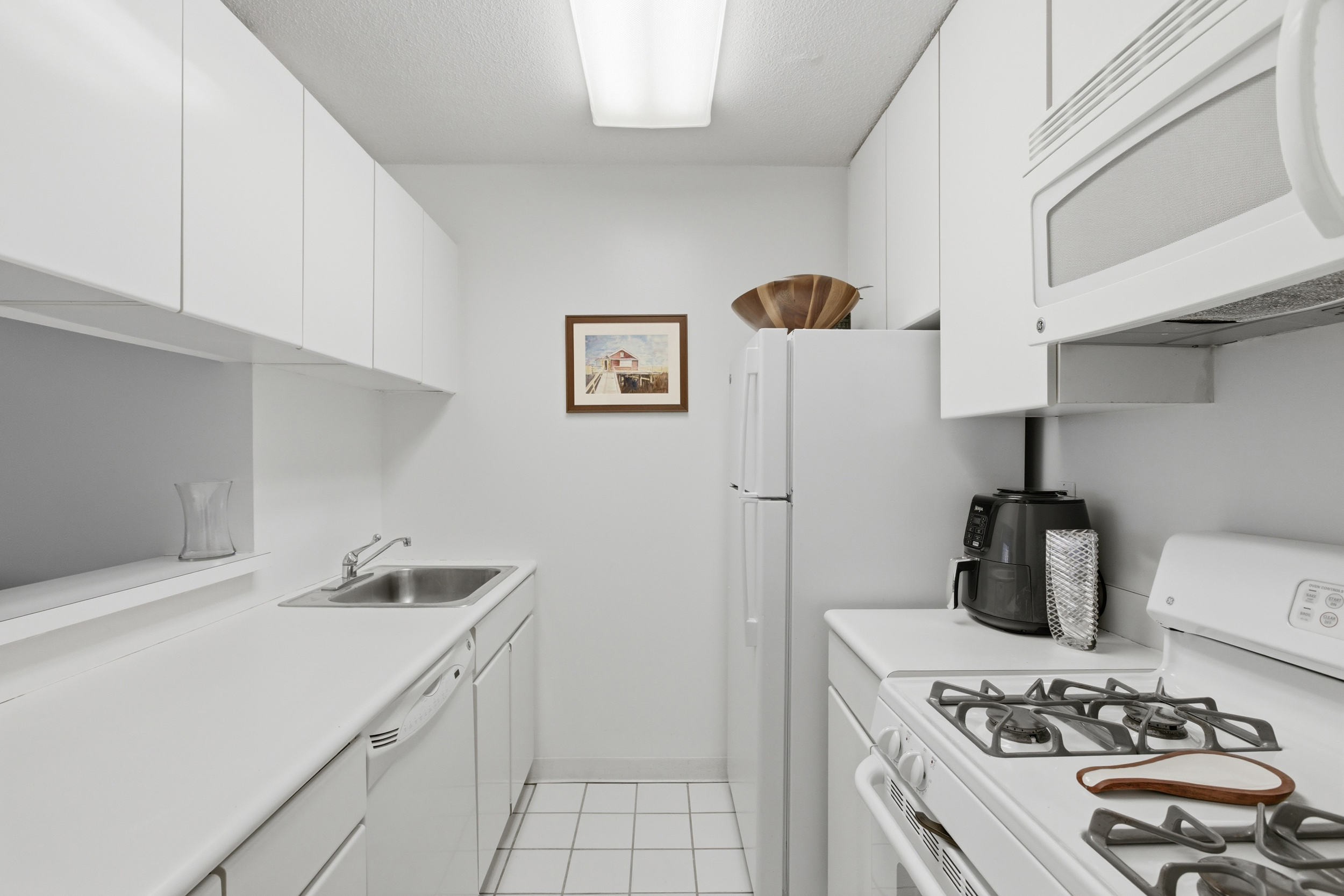 280 Park Avenue South, Unit 5L Manhattan, NY 10010 - Photo 5 of 17 a kitchen with stainless steel appliances a sink a stove and a refrigerator
