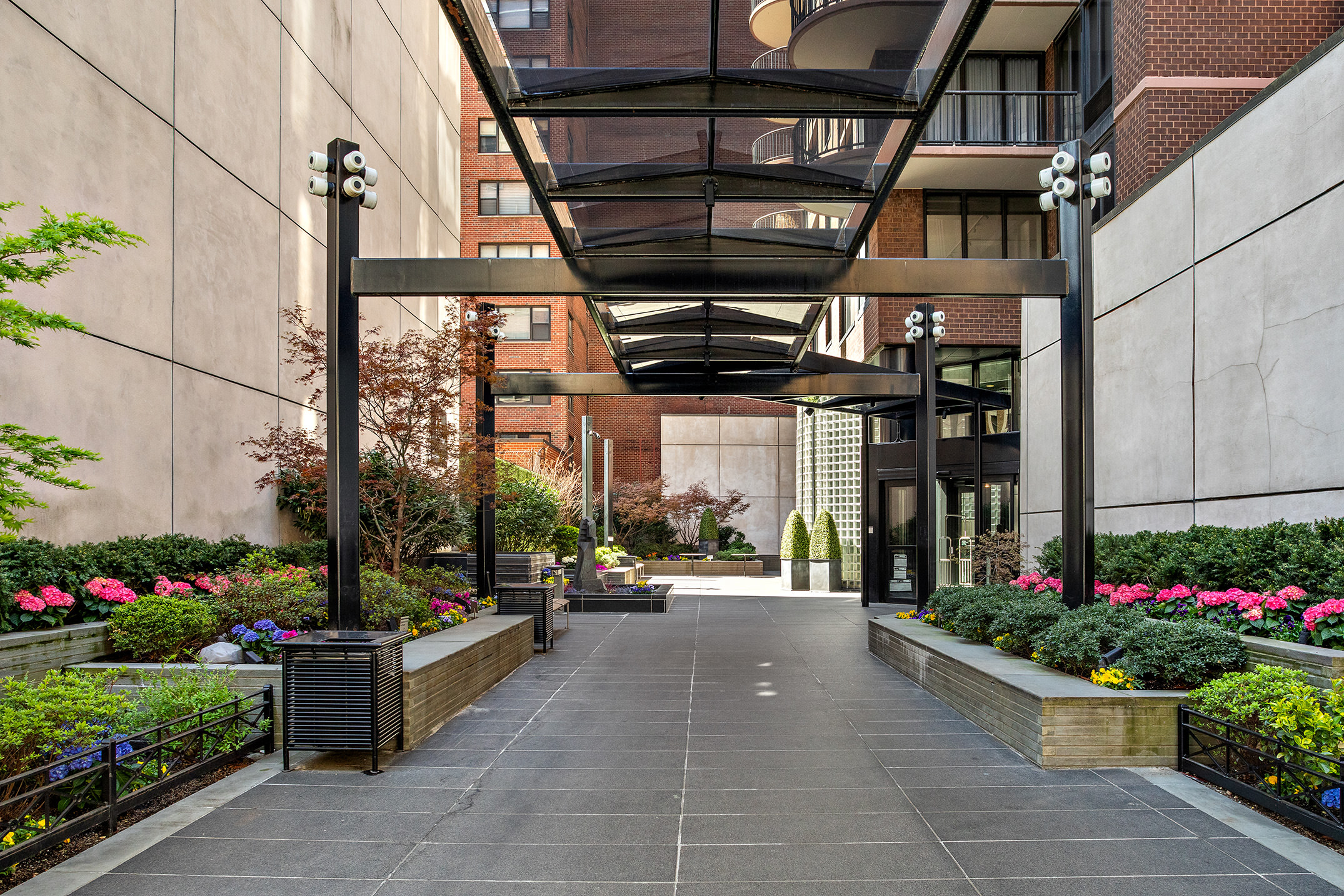 304 East 65th Street, Unit 10D Manhattan, NY 10065 - Photo 13 of 14 a front view of a building with flowers