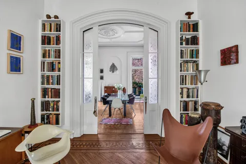 a living room with furniture and a book shelf