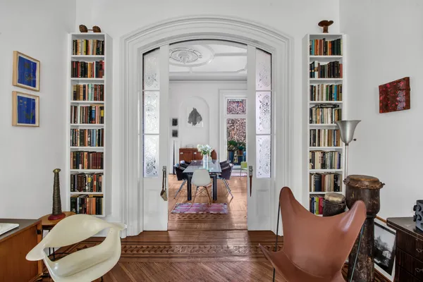 a living room with furniture and a book shelf