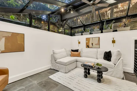 a front view of a building with a garden