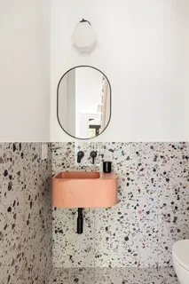 a bathroom with a sink mirror and toilet