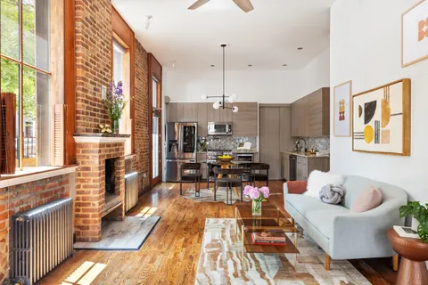 a living room with furniture and large windows