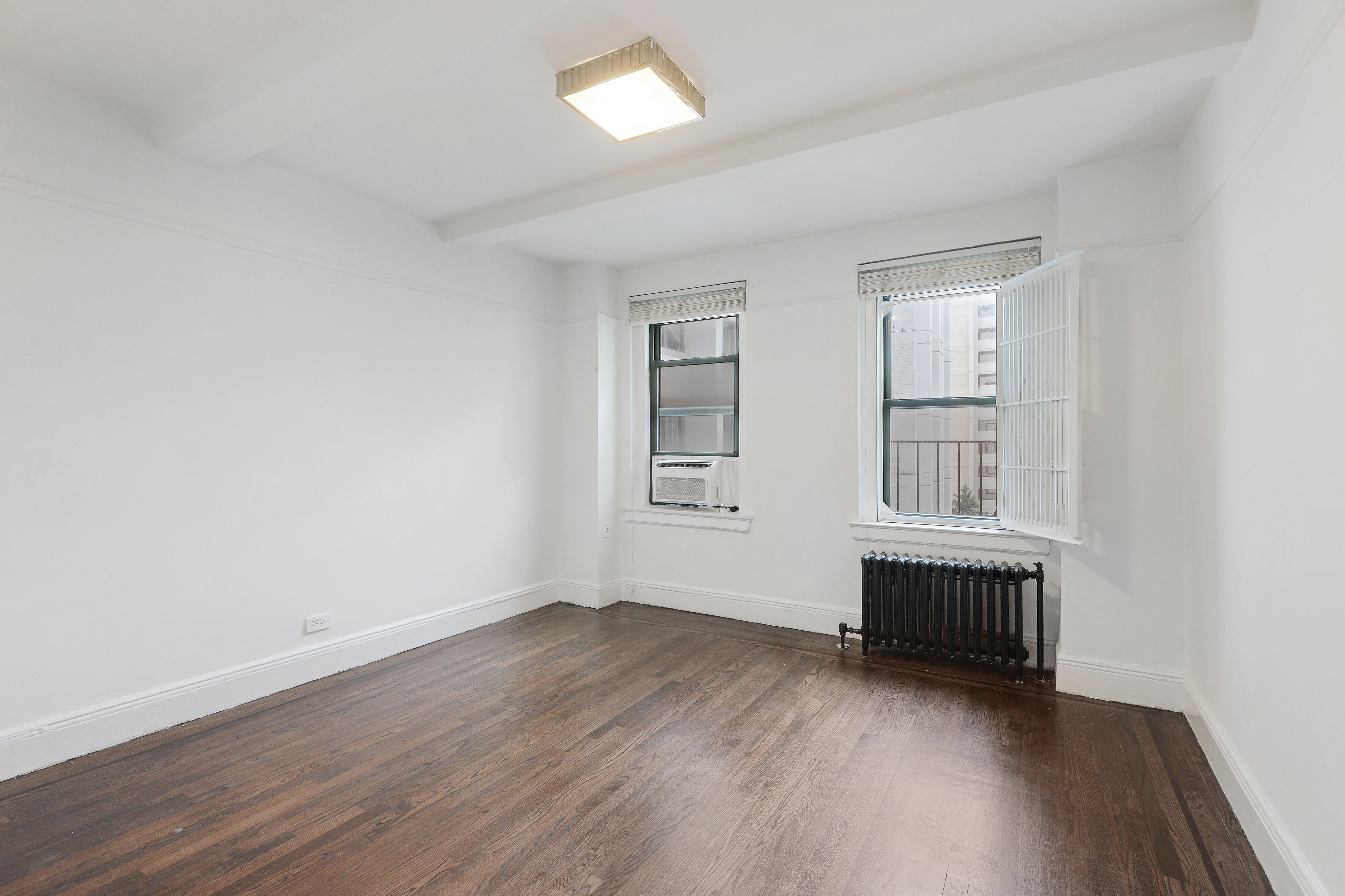 65 West 95th Street, Unit 4D Manhattan, NY 10025 - Photo 8 of 11 an empty room with wooden floor and windows