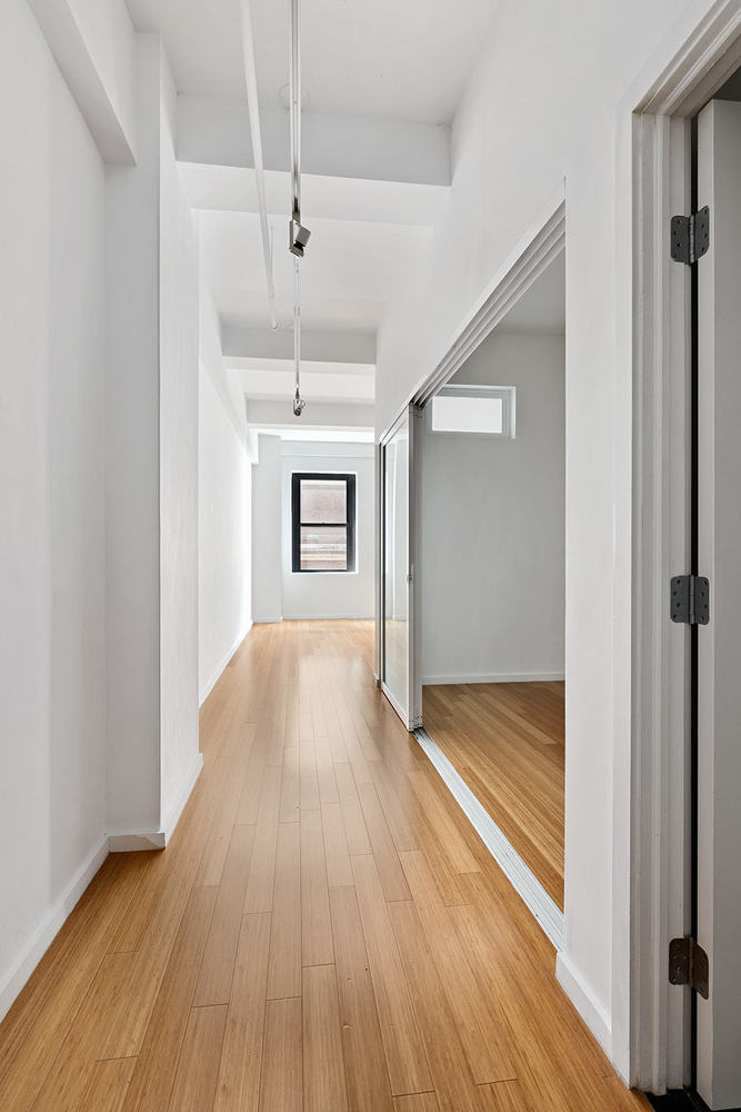 365 Bridge Street, Unit 8L Brooklyn, NY 11201 - Photo 6 of 21 a view of an empty room and wooden floor
