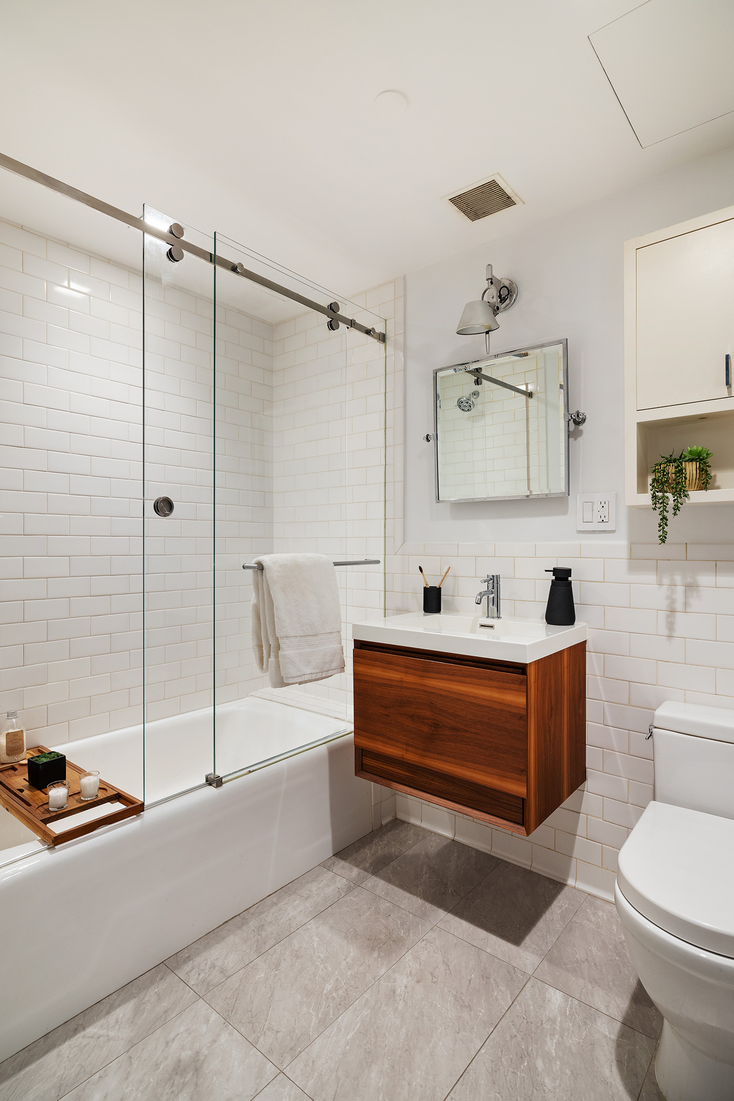 41 Warren Street, Unit 6 Manhattan, NY 10007 - Photo 17 of 23 a spacious bathroom with a tub mirror and toilet