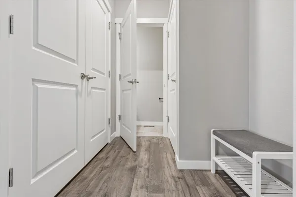 a view of a hallway with wooden floor