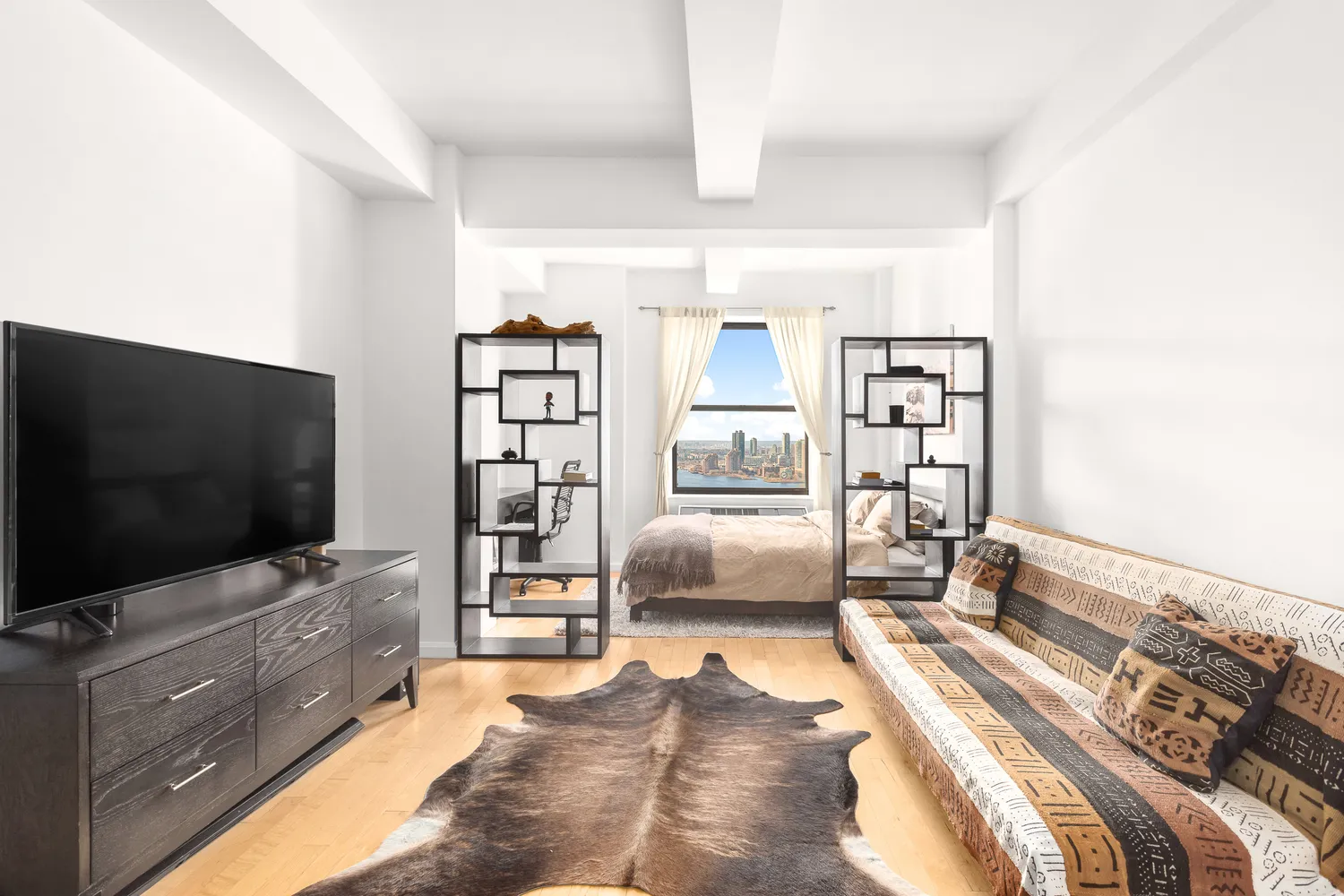 a bedroom with furniture and a flat screen tv