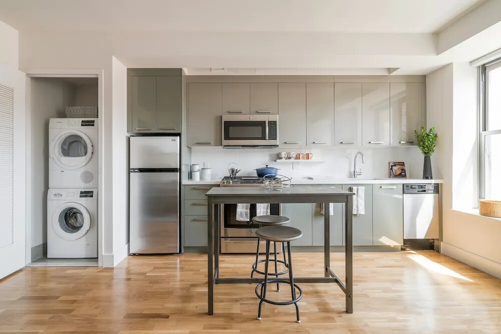 310 Clarkson Avenue, Unit 523 Brooklyn, NY 11226 - Photo 2 of 14 a kitchen with stainless steel appliances granite countertop a refrigerator and a stove top oven