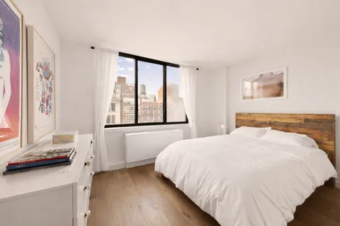 a bedroom with a large bed and a window