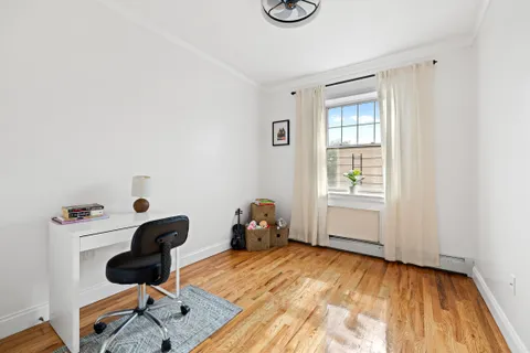 a bedroom with a workspace