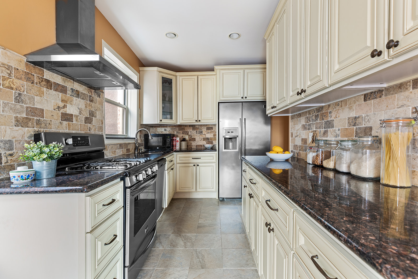 9281 Shore Road, Unit 207 Brooklyn, NY 11209 - Photo 3 of 11 a kitchen with stainless steel appliances granite countertop a sink stove and refrigerator