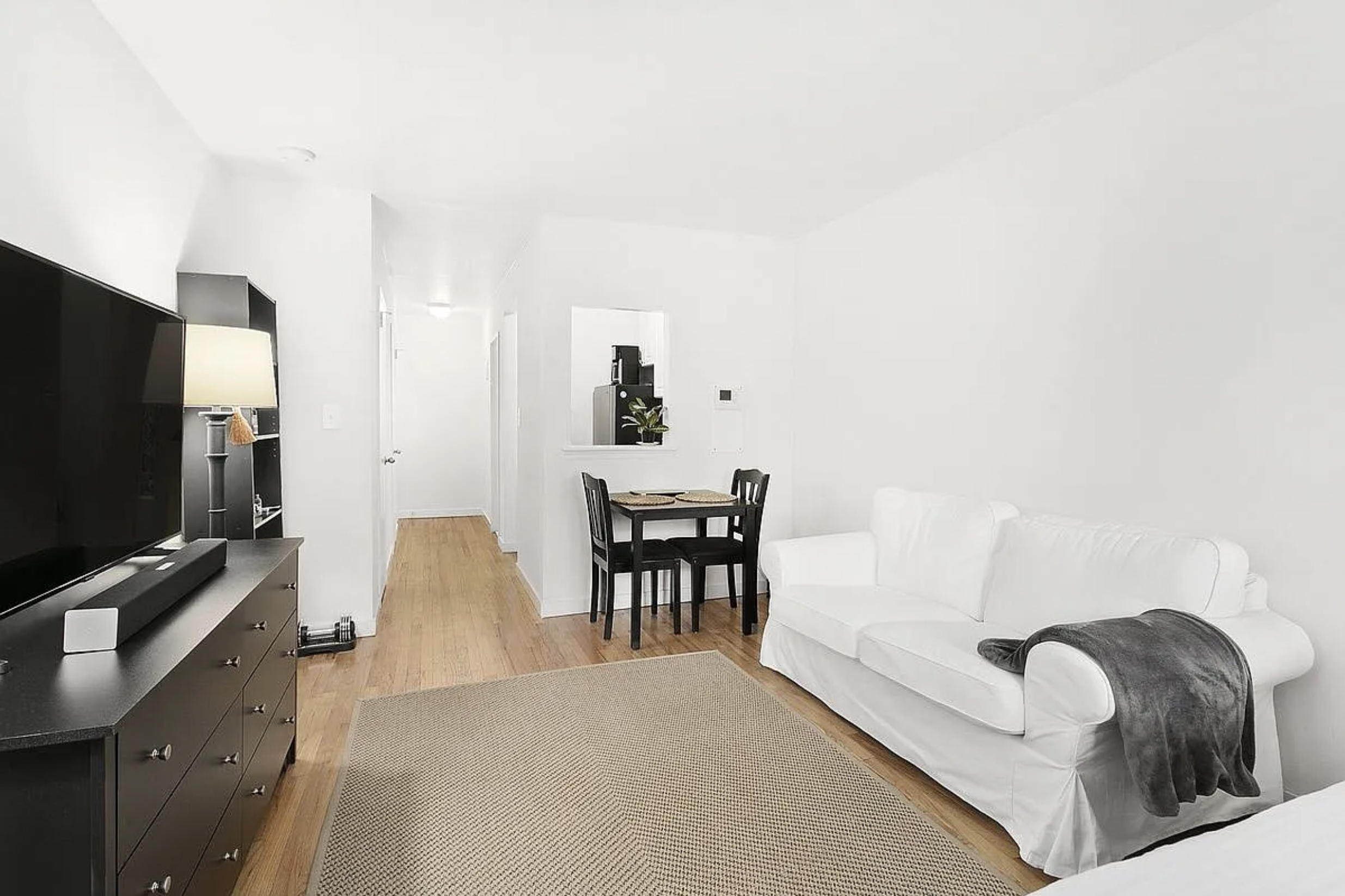 343 East 76th Street, Unit 5D Manhattan, NY 10021 - Photo 3 of 7 a living room with furniture and a flat screen tv
