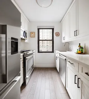 a kitchen with stainless steel appliances a white stove top oven and sink