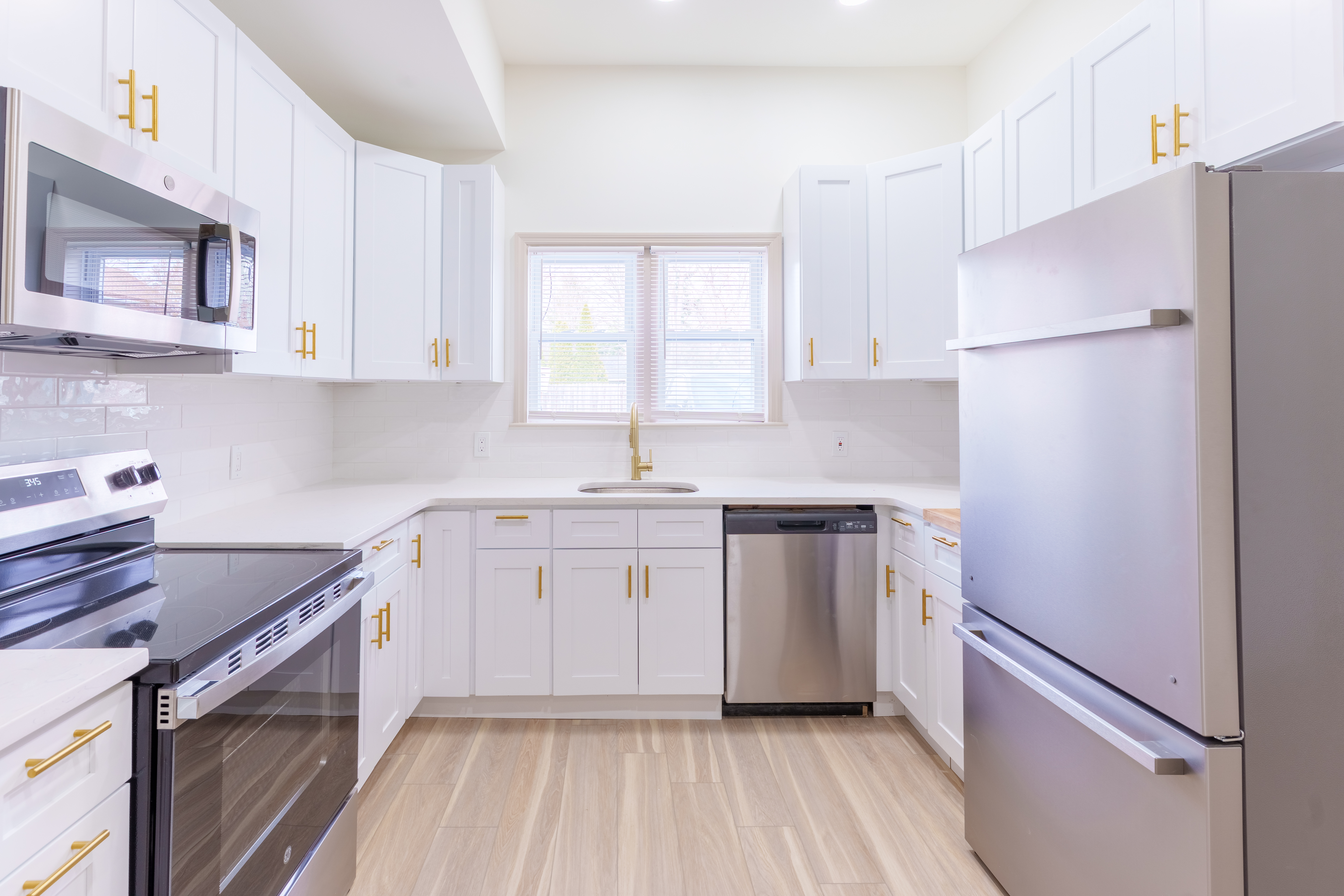 415 North Haddon Avenue Haddonfield, NJ 08033 - Photo 5 of 23 a kitchen with a sink cabinets stainless steel appliances and a window