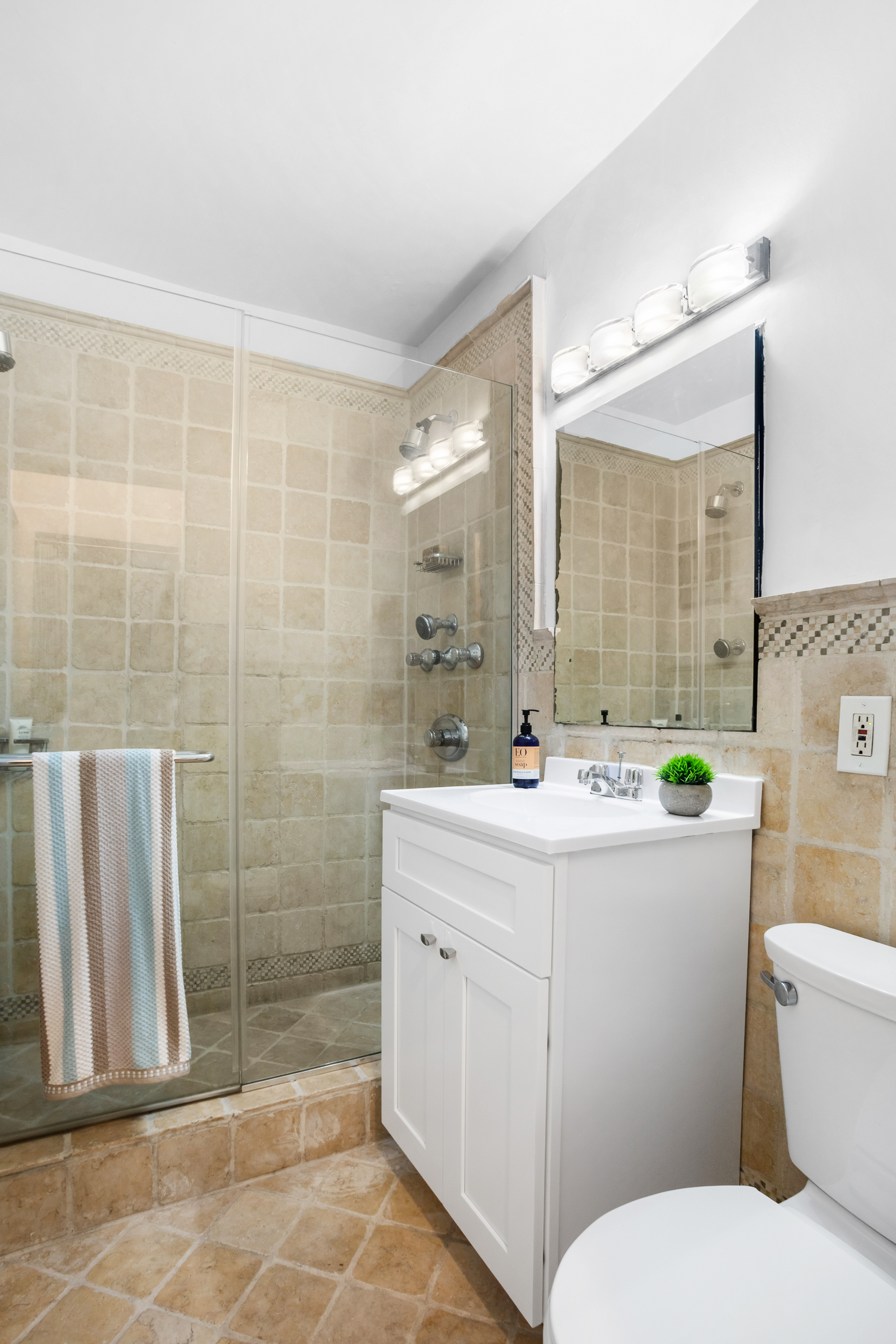 130 East 18th Street, Unit 1G Manhattan, NY 10003 - Photo 8 of 14 a bathroom with a sink a toilet and shower