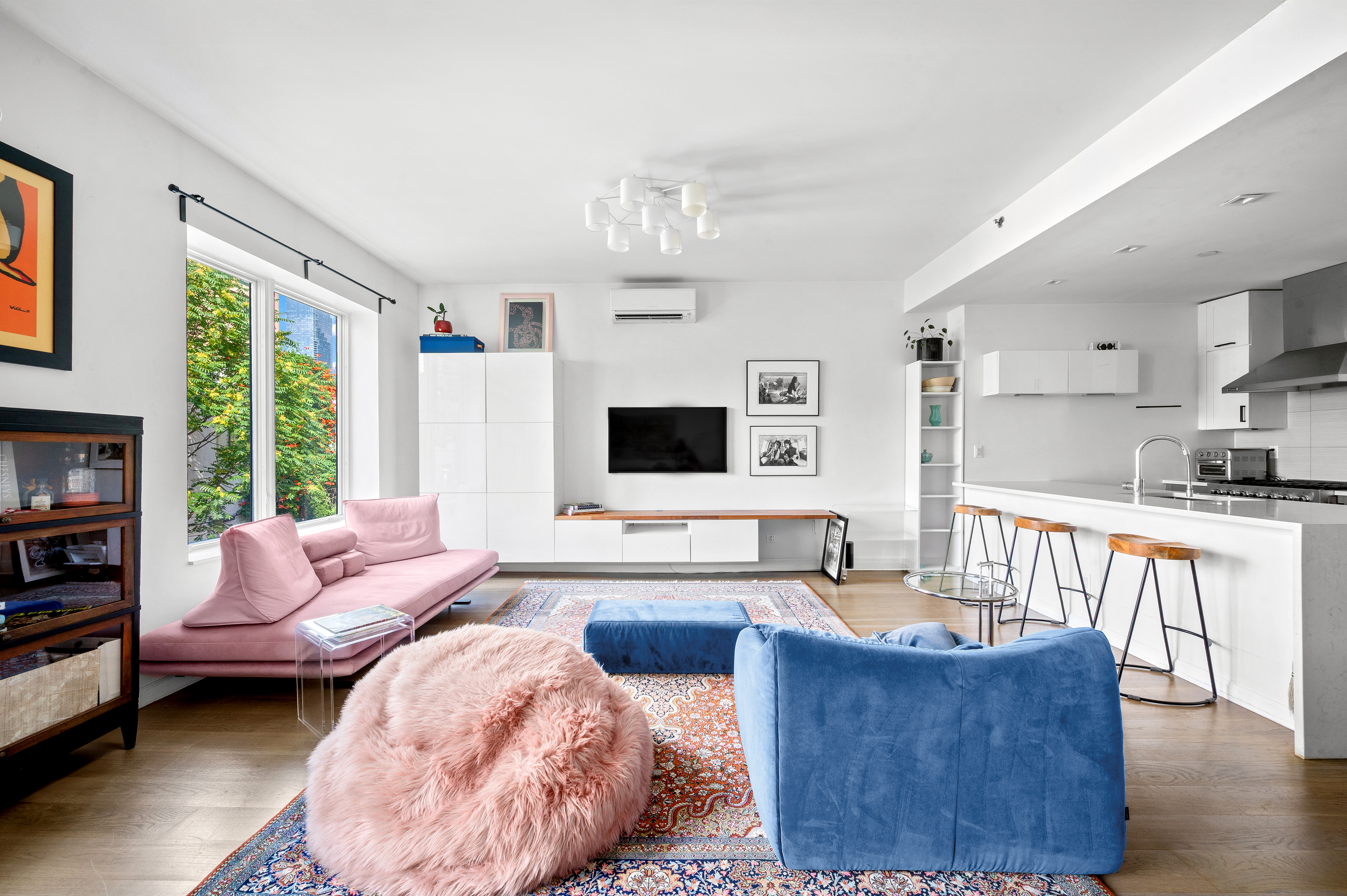 5-41 47th Road, Unit 2B Queens, NY 11101 - Photo 1 of 10 a living room with furniture wooden floor and a flat screen tv
