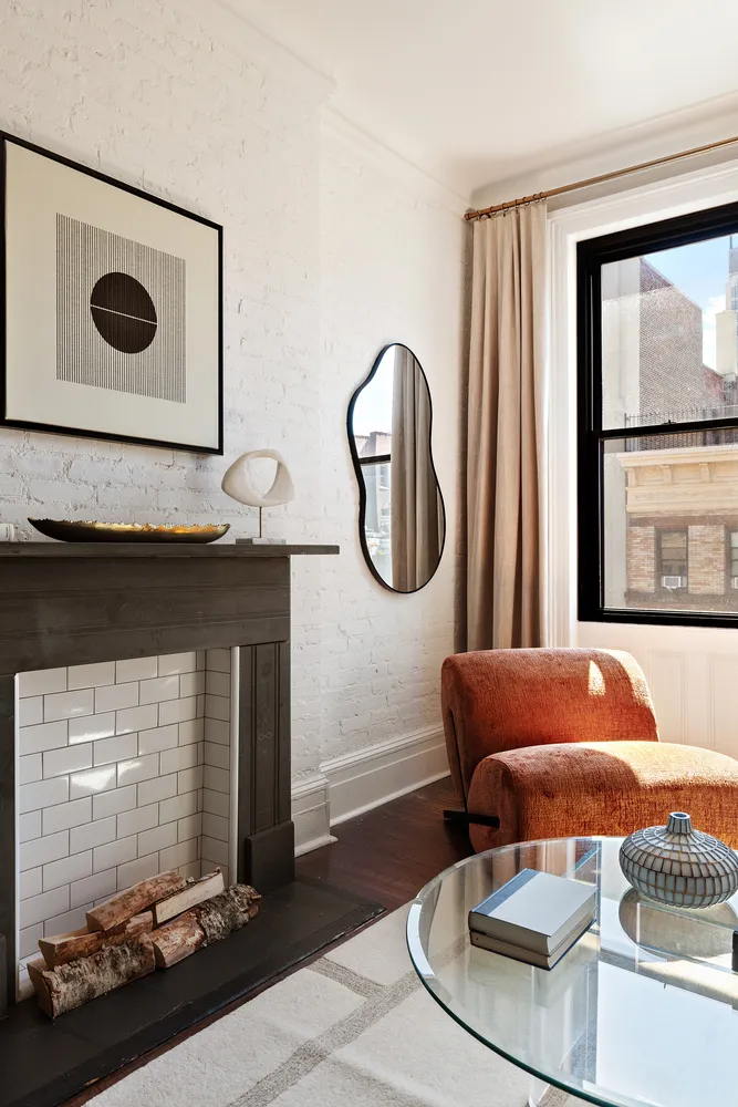 a living room with furniture and a painting