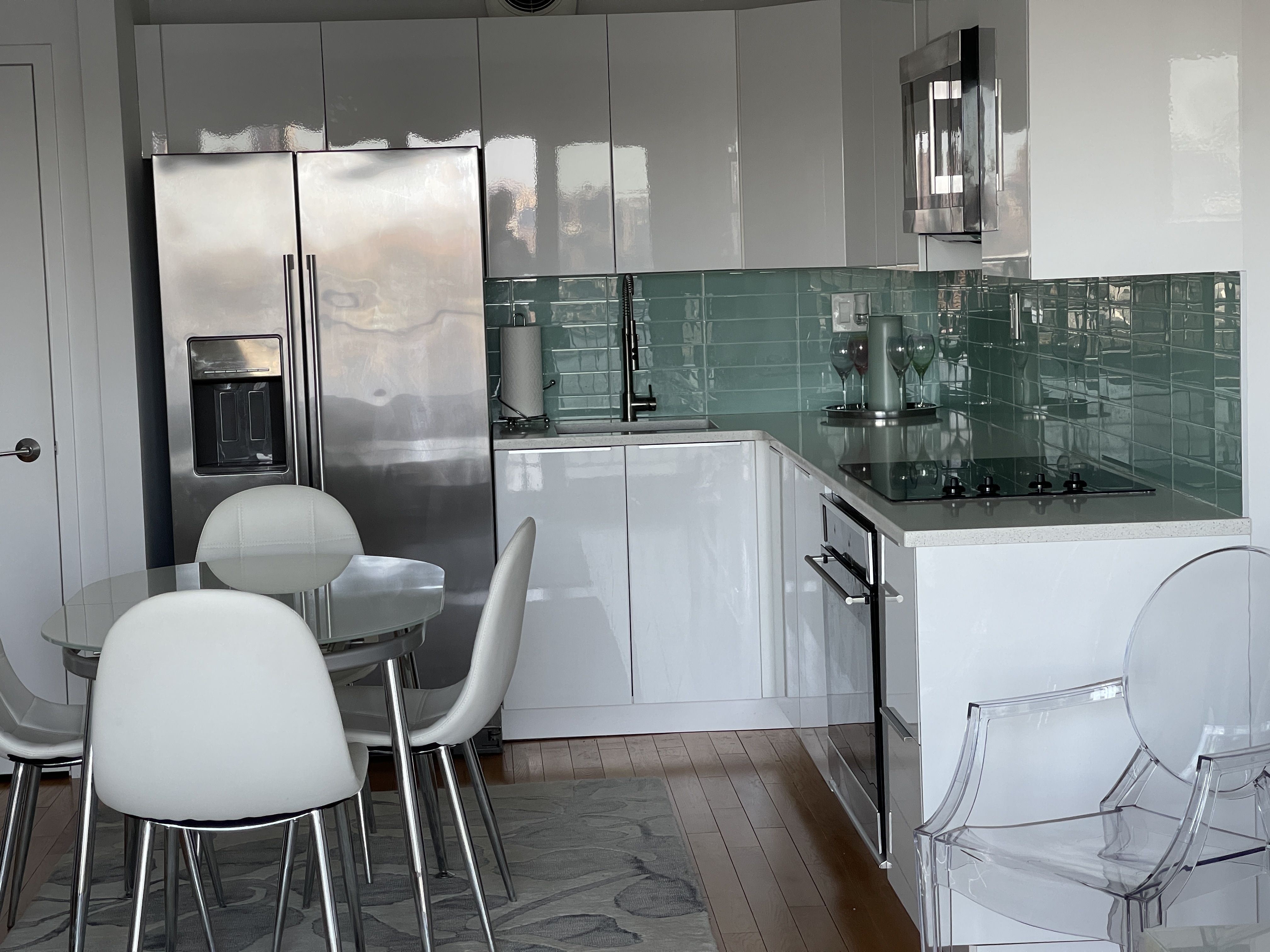 25-40 Shore Boulevard, Unit 15T Queens, NY 11102 - Photo 5 of 22 a kitchen with a table chairs and entryway