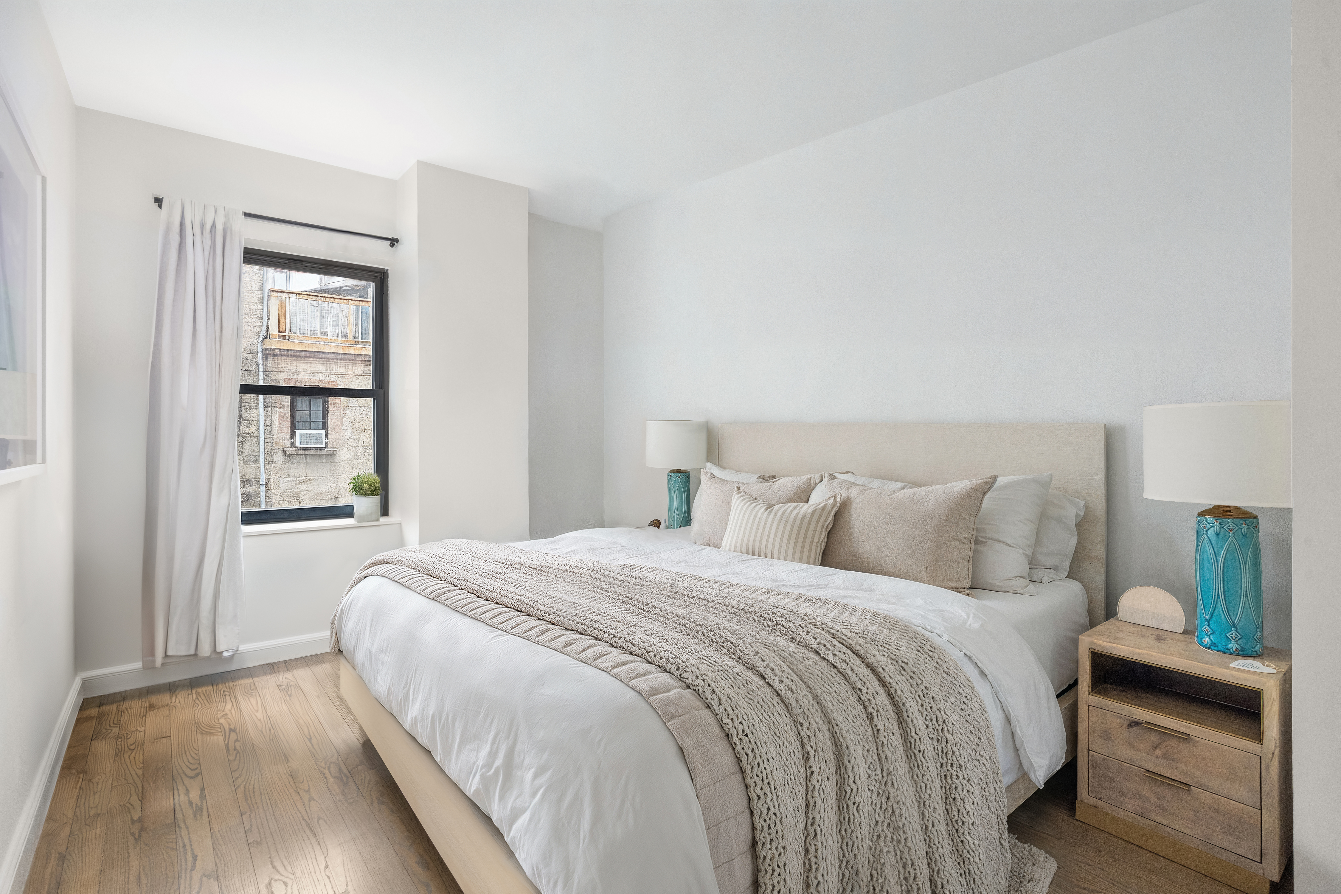 253 West 73rd Street, Unit 4N Manhattan, NY 10023 - Photo 6 of 9 a bedroom with a bed and a window