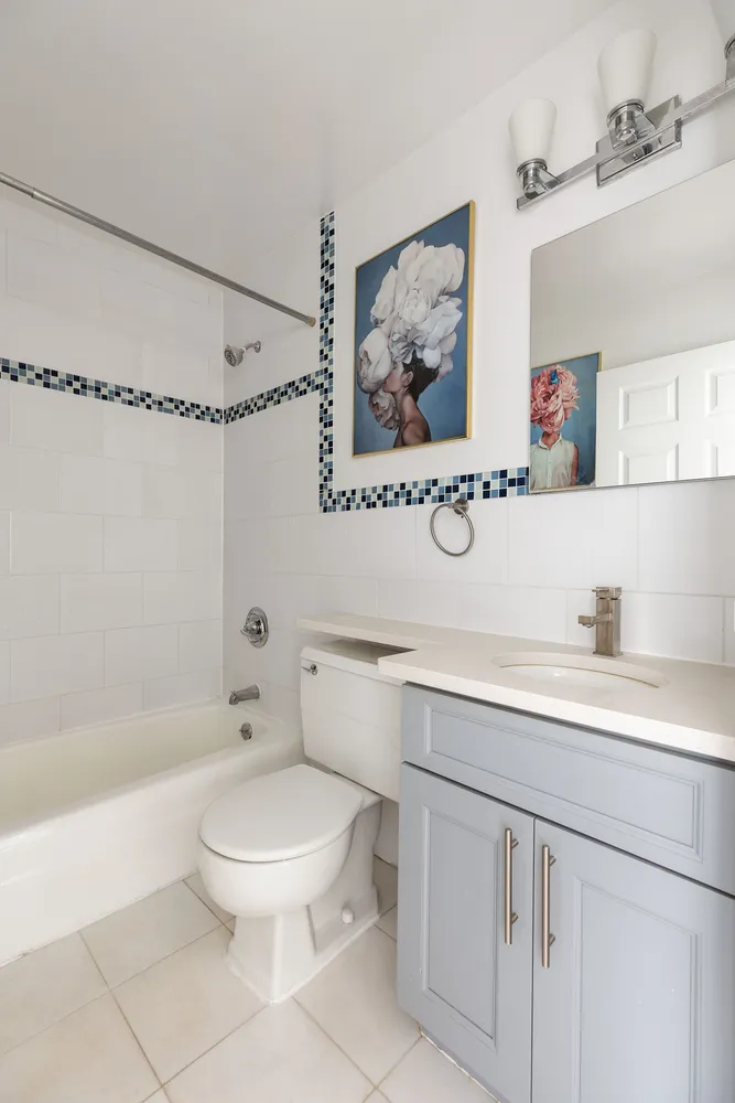 a bathroom with a toilet sink a mirror and shower