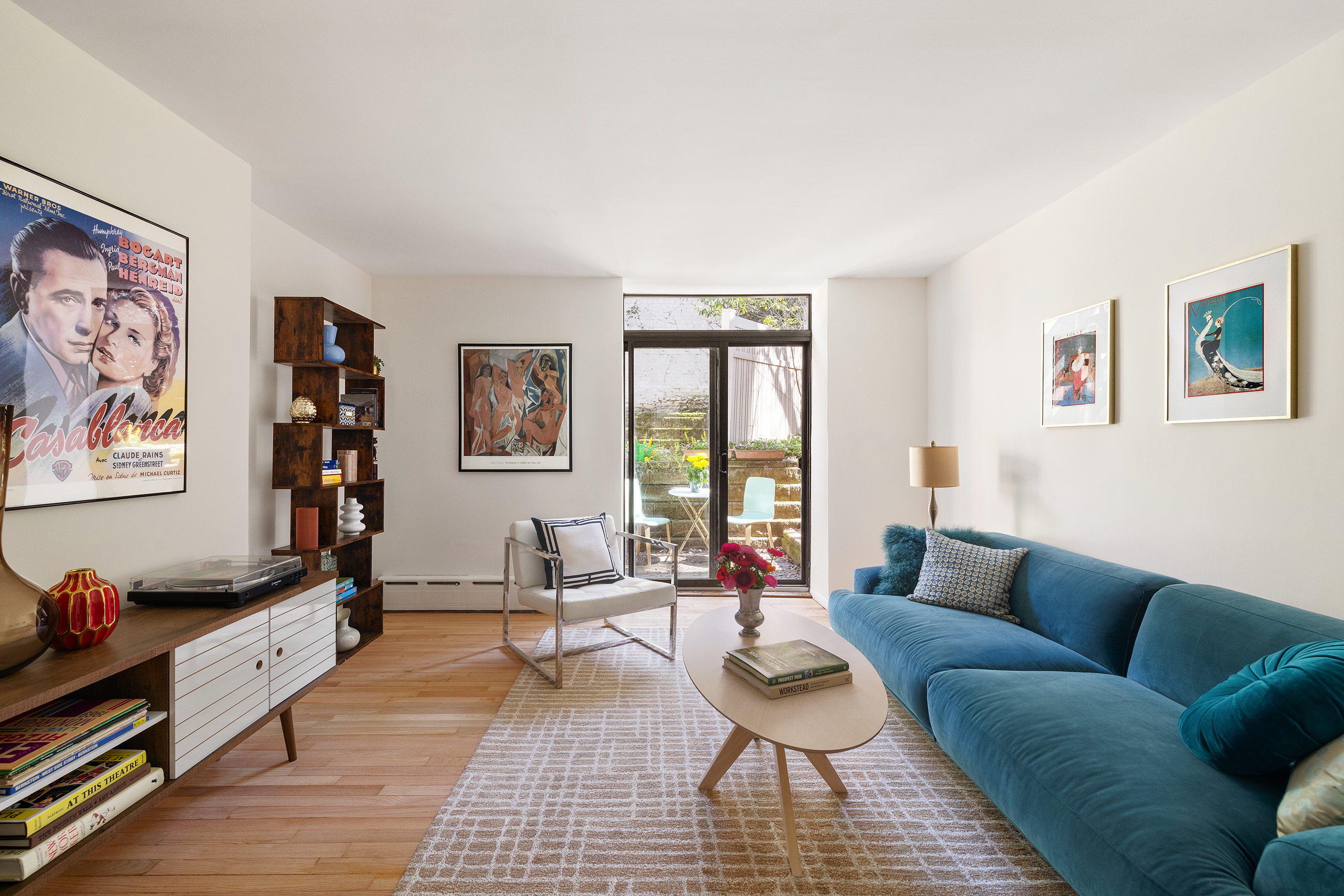 a living room with furniture and wooden floor