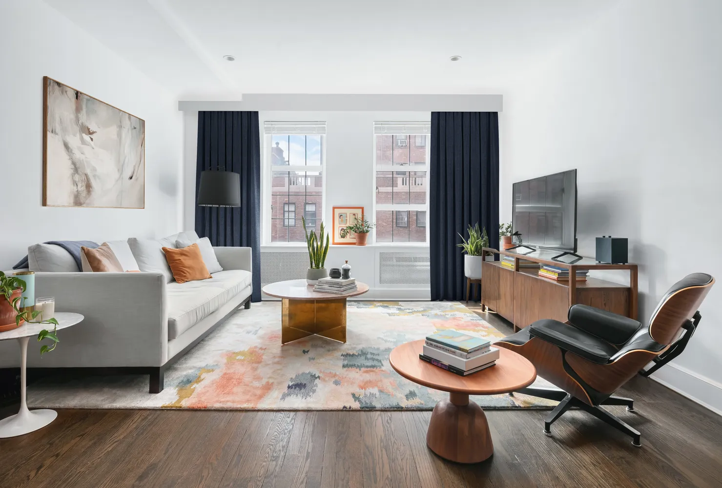 a living room with furniture and a wooden floor