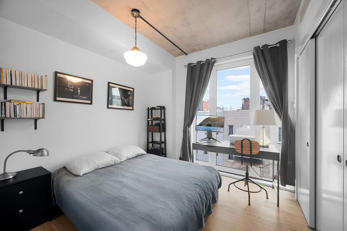 169 Huron Street, Unit 4A Brooklyn, NY 11222 - Photo 6 of 15 a bedroom with a bed and a large window with the outer view