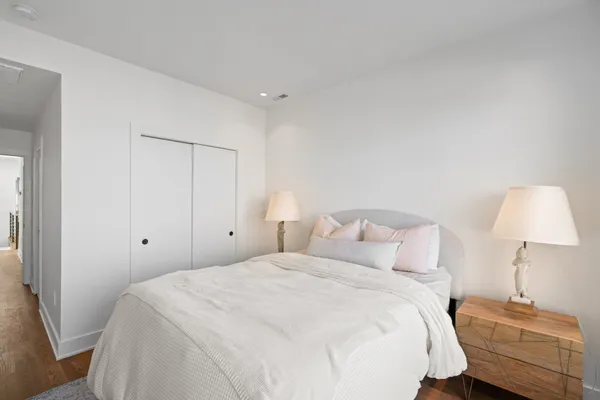 a bedroom with a bed and a lamp