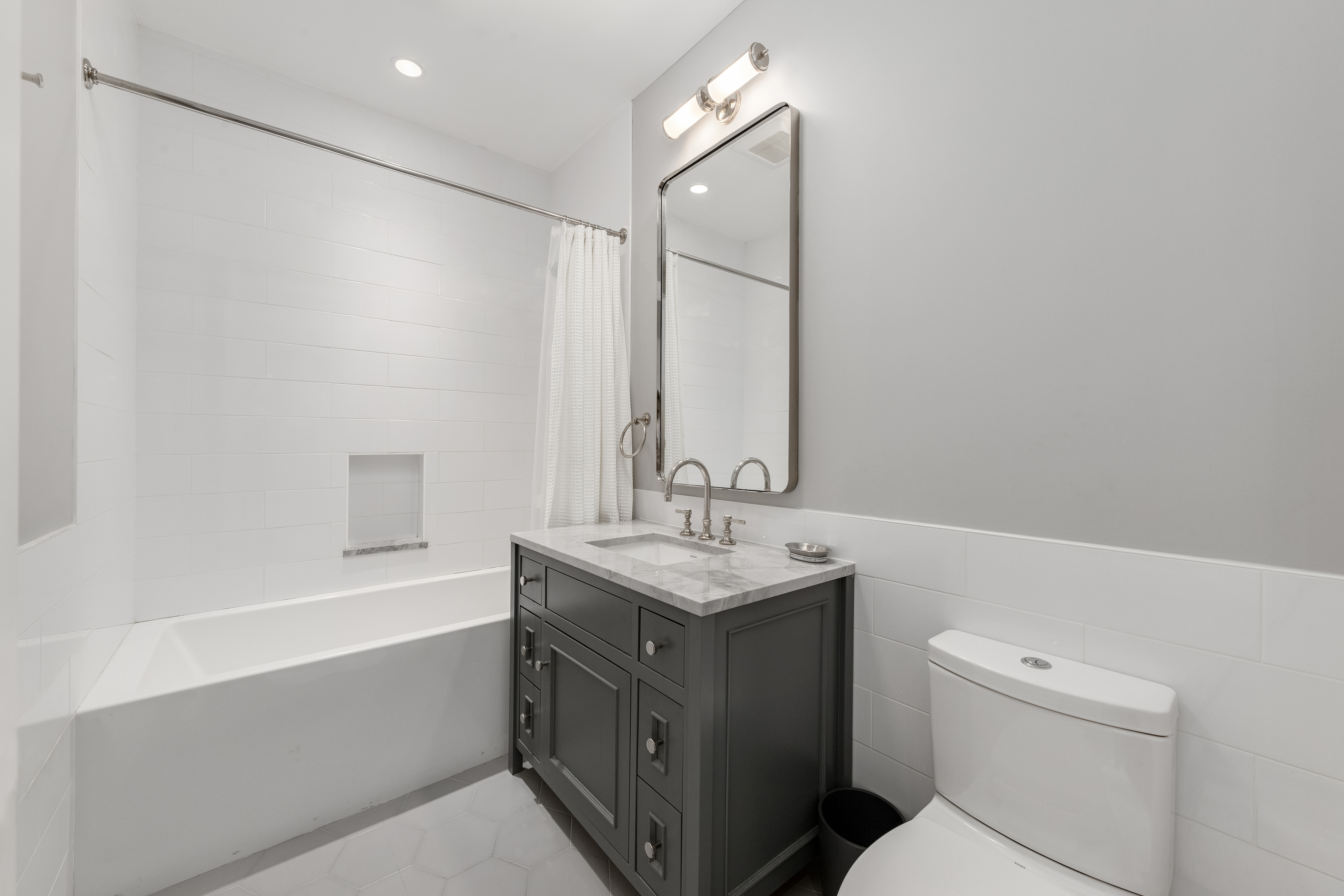 110 West 81st Street Manhattan, NY 10024 - Photo 7 of 30 a bathroom with a granite countertop sink a toilet and a bathtub