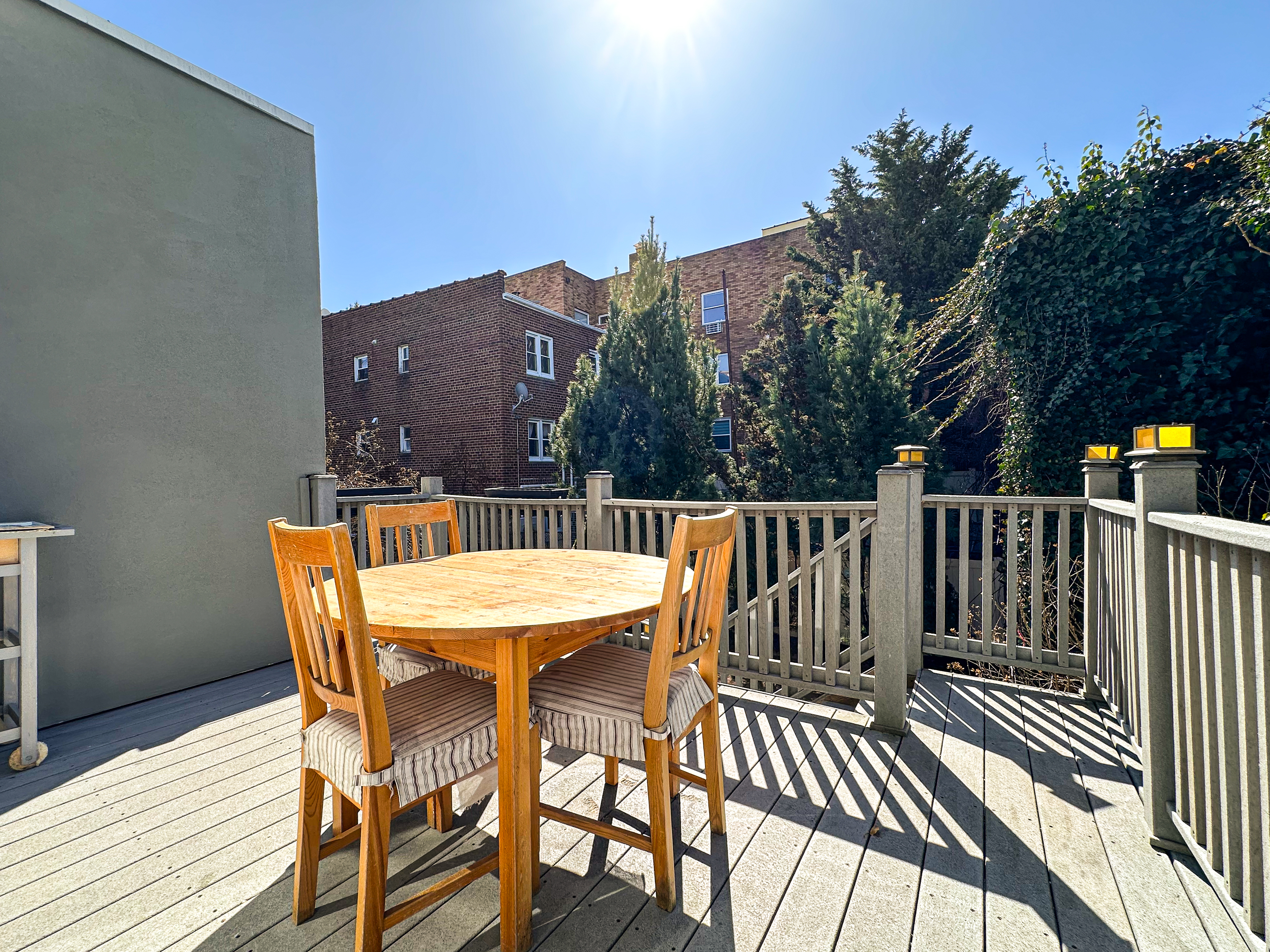 66-42 Clinton Avenue, Unit 2 Queens, NY 11378 - Photo 4 of 14 a balcony with table and chairs