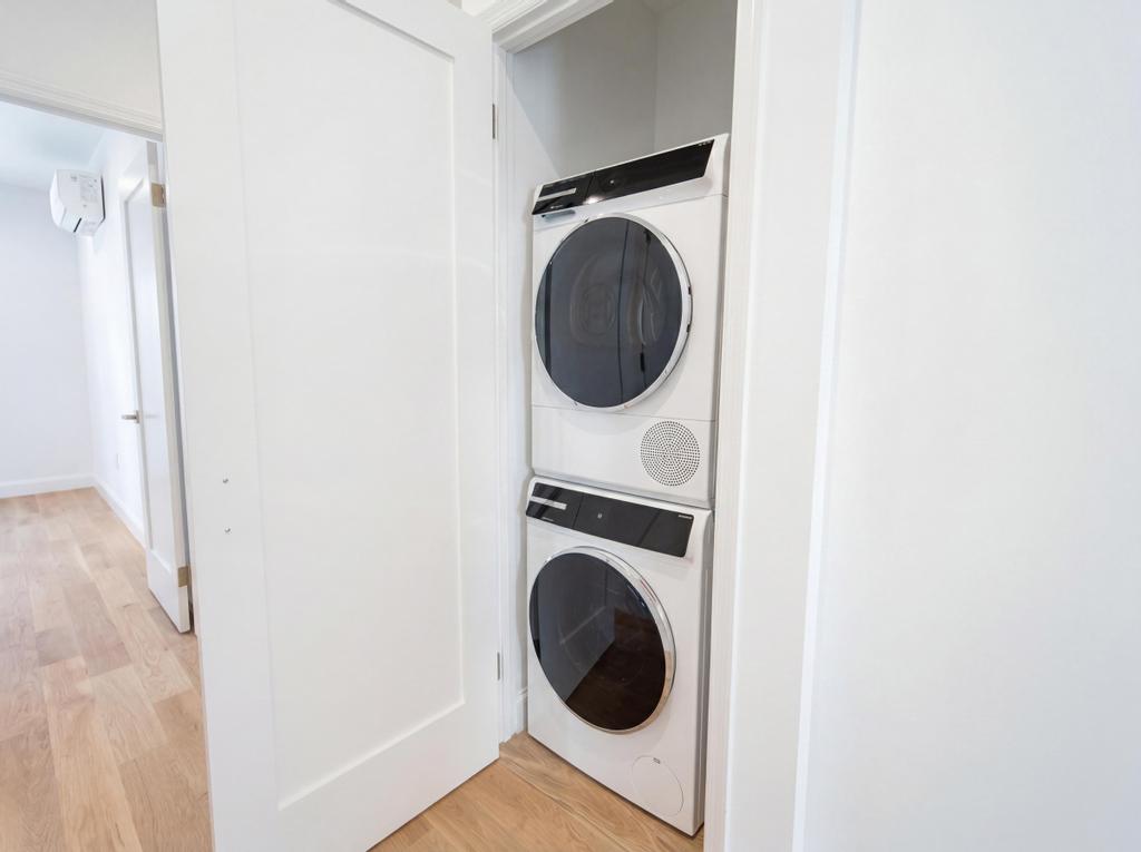 231 East 60th Street, Unit 5 Manhattan, NY 10022 - Photo 6 of 11 a close view of a utility room with dryer and washer