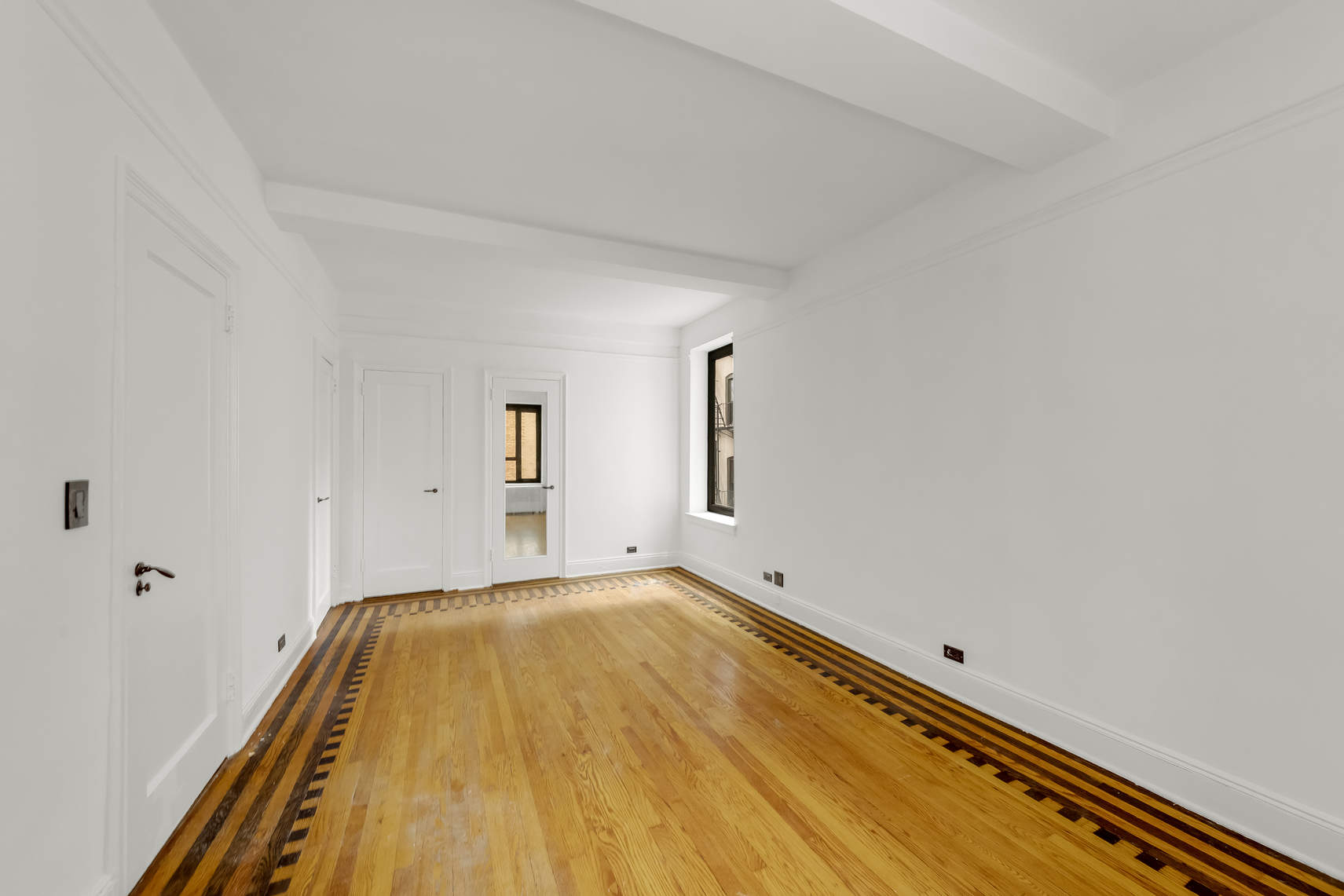 444 Central Park West, Unit 2H Manhattan, NY 10025 - Photo 8 of 16 a view of a room with wooden floor and small window