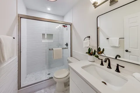 a bathroom with a sink toilet and shower
