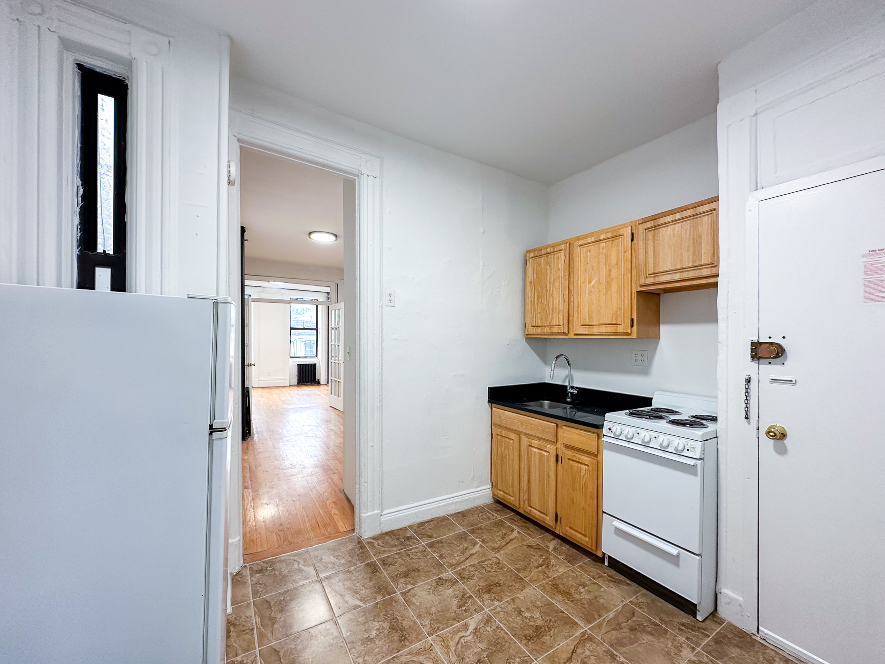 338 East 5th Street, Unit 17 Manhattan, NY 10003 - Photo 5 of 14 a kitchen with a stove a refrigerator and a sink