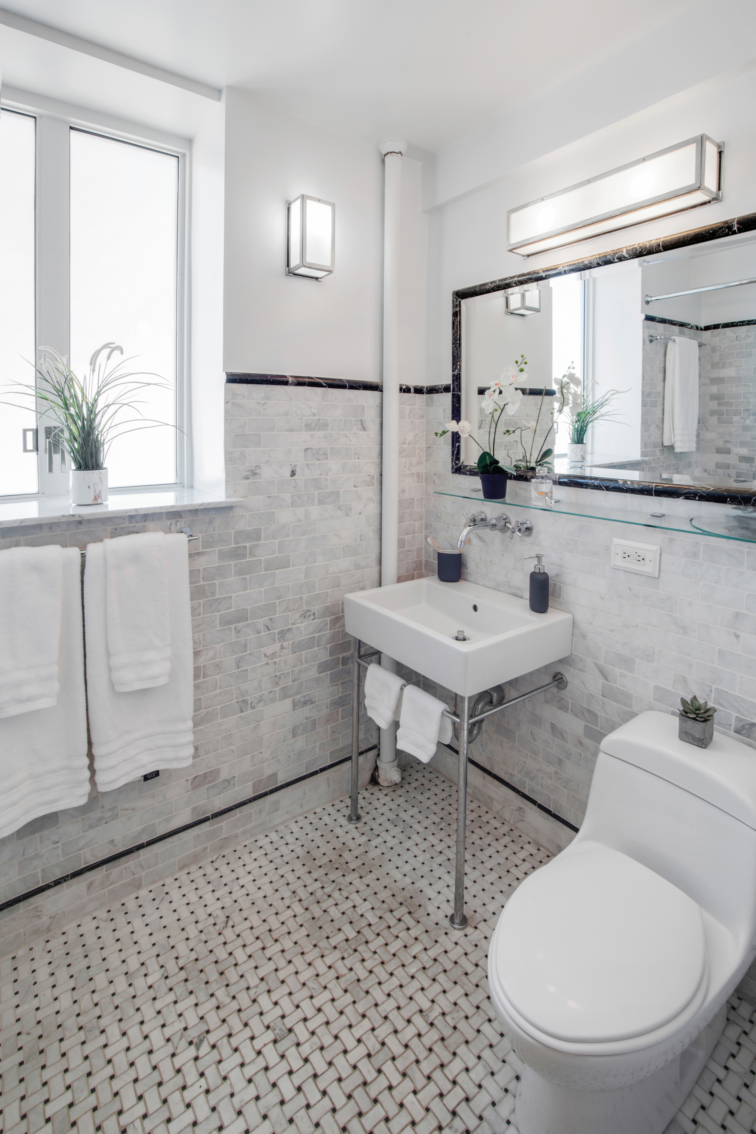 200 West 20th Street, Unit 1409/10 Manhattan, NY 10011 - Photo 7 of 15 a bathroom with a toilet a sink and mirror