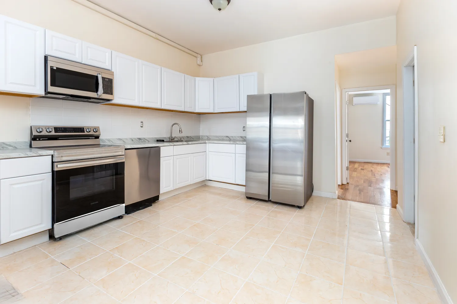 a kitchen with stainless steel appliances granite countertop a refrigerator a stove top oven a sink and dishwasher