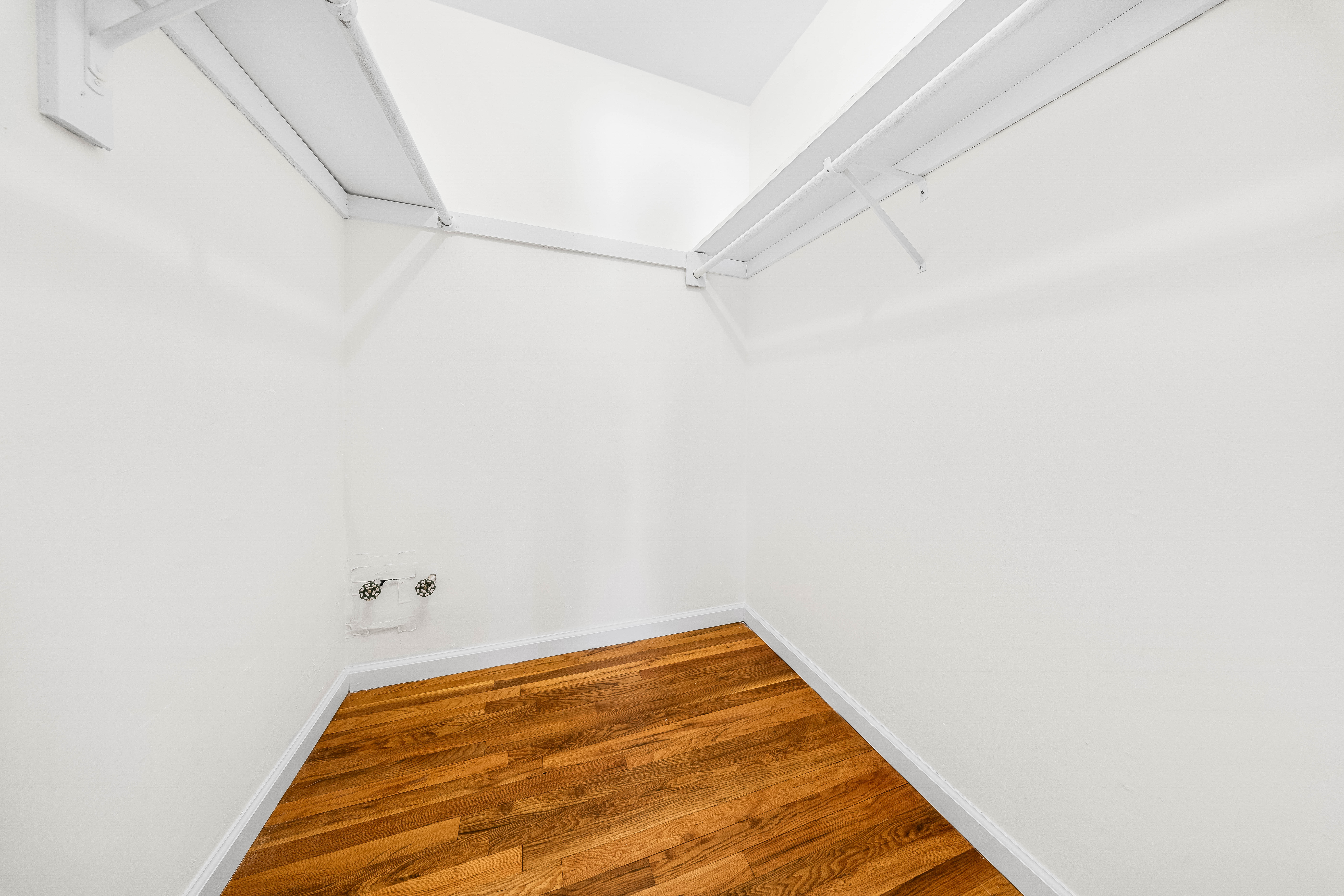 15-80 209th Street, Unit 2 Queens, NY 11360 - Photo 13 of 21 a view of a room with racks on the wall